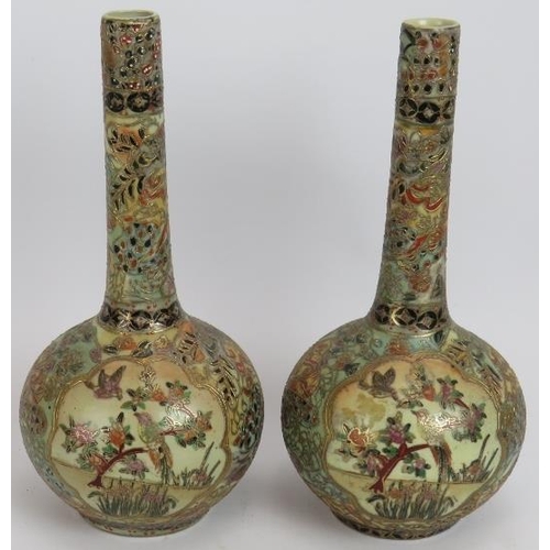 67 - A pair of Japanese porcelain Satsuma bottle vases richly decorated with gilt and polychrome colours.... 