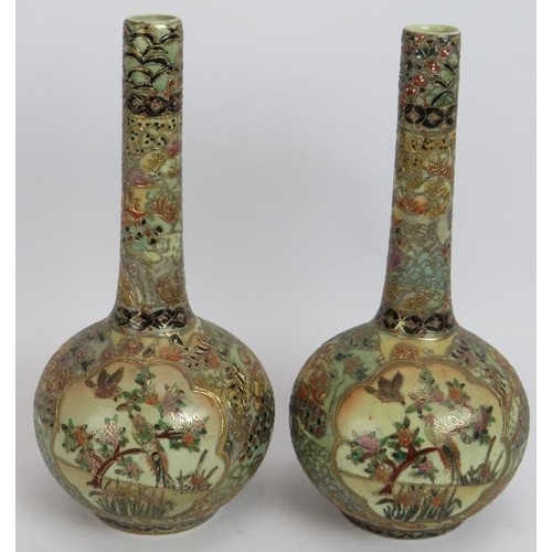 67 - A pair of Japanese porcelain Satsuma bottle vases richly decorated with gilt and polychrome colours.... 