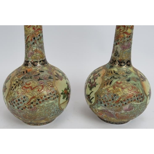 67 - A pair of Japanese porcelain Satsuma bottle vases richly decorated with gilt and polychrome colours.... 