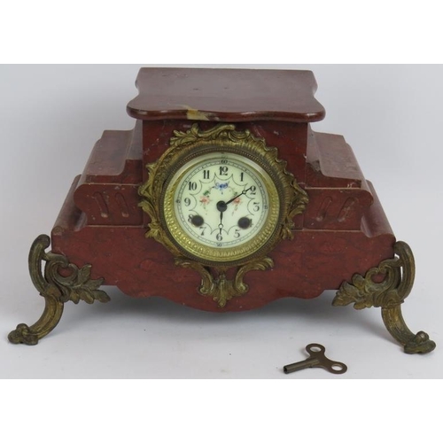 69 - An antique French red marble mantle clock with enamelled dial and gilt brass mounts. Note: the movem... 