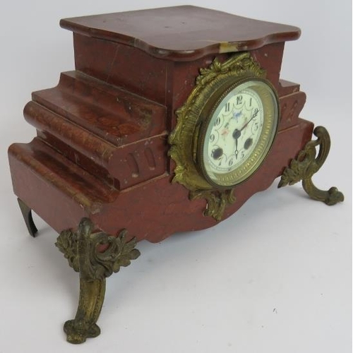 69 - An antique French red marble mantle clock with enamelled dial and gilt brass mounts. Note: the movem... 