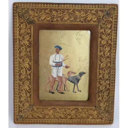 71 - An antique Indian painting on mica of a man and hounds mounted behind glass in a gilt mounted leathe... 