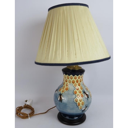 76 - A Moorcroft pottery honeycomb and bees lamp with original label and shade. Lamp base height 28cm.
Co... 