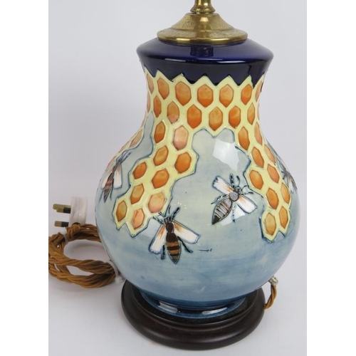 76 - A Moorcroft pottery honeycomb and bees lamp with original label and shade. Lamp base height 28cm.
Co... 