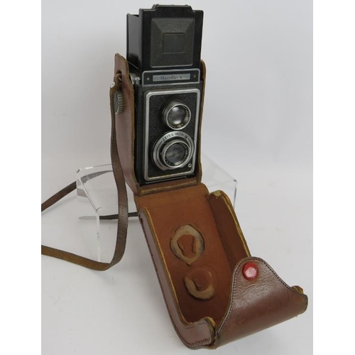 83 - An Ikoflex TLR camera with leather case, a Eumig C3R Cine camera with case and a Kodak Brownie 127 w... 