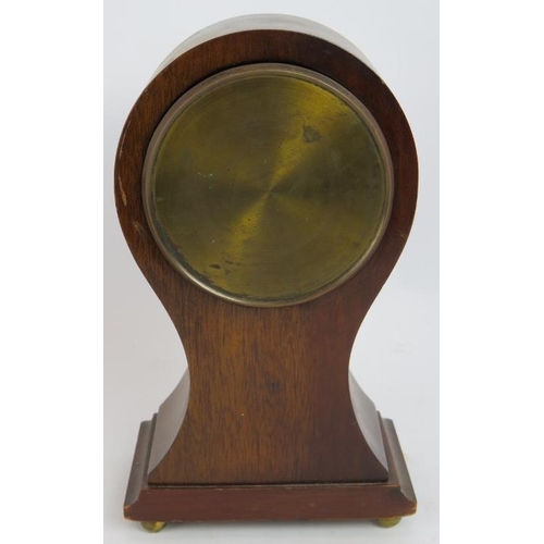 89 - A small Edwardian baloon shaped mantle clock with inlaid walnut case and French movement. No key. He... 