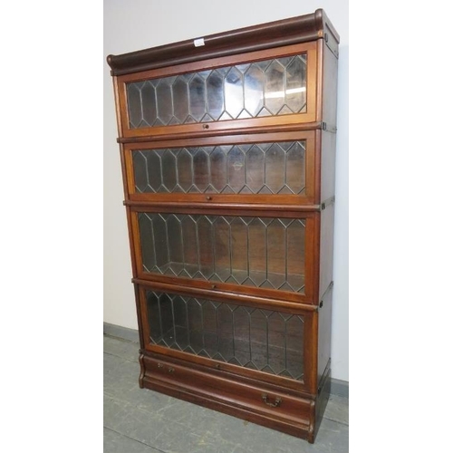 703 - A vintage mahogany Globe-Wernicke stacking bookcase of four graduated sections, the glazed doors wit... 