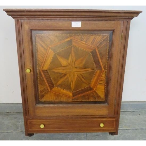 707 - A vintage wall hanging cabinet, the panelled door featuring starburst parquetry inlay with one long ... 