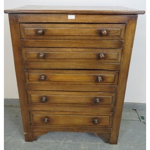 709 - A vintage period style oak chest of five graduated drawers, with turned handles, on bracket feet. 
C... 