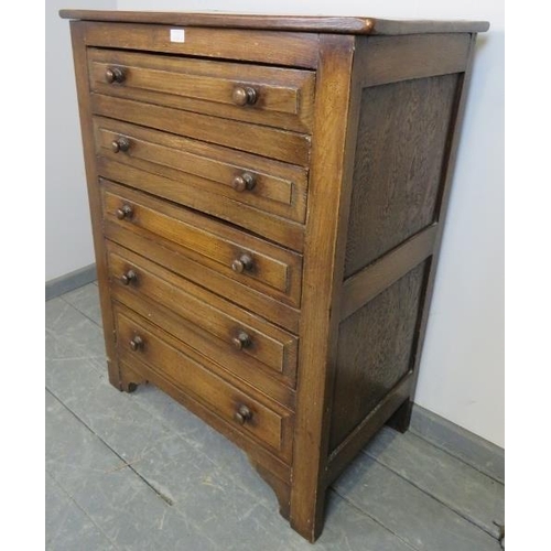 709 - A vintage period style oak chest of five graduated drawers, with turned handles, on bracket feet. 
C... 