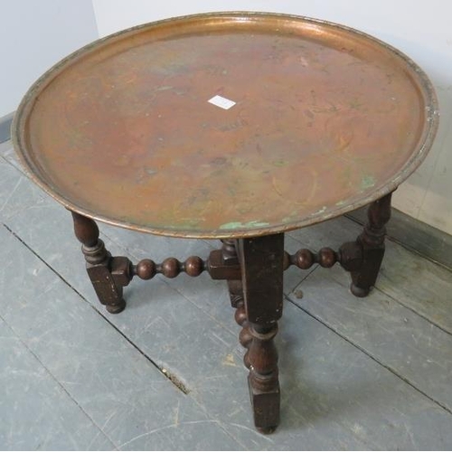 715 - A 19th century Arts & Crafts copper tray table by Hugh Wallis, on a turned and block folding oak sta... 