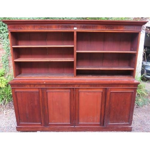 716 - A very large Victorian mahogany bookcase, of four height adjustable open shelves above four cupboard... 