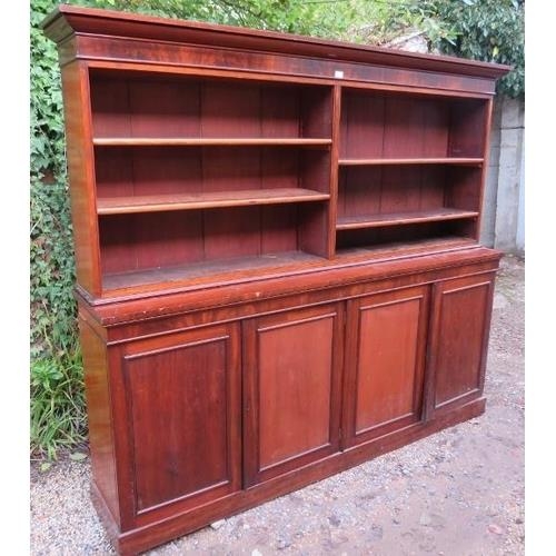 716 - A very large Victorian mahogany bookcase, of four height adjustable open shelves above four cupboard... 