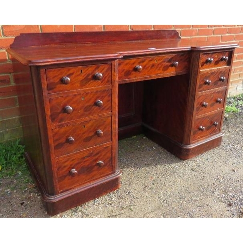 719 - A Victorian mahogany reverse breakfront kneehole desk, with rear gallery, housing a configuration of... 