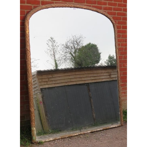 720 - A very large 19th century arched overmantle mirror, retaining the original mercury glass plate, in a... 