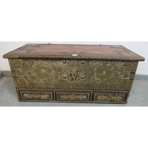 721 - A 19th century hardwood Zanzibar chest, featuring pierced brass decoration and a multitude of brass ... 