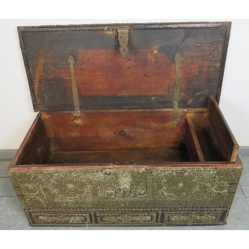 721 - A 19th century hardwood Zanzibar chest, featuring pierced brass decoration and a multitude of brass ... 