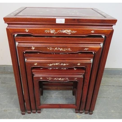 724 - A vintage Chinese hardwood quartetto of nesting tables, featuring mother of pearl inlay depicting so... 