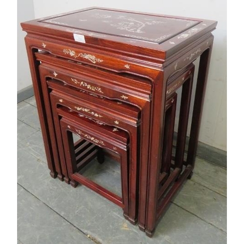 724 - A vintage Chinese hardwood quartetto of nesting tables, featuring mother of pearl inlay depicting so... 