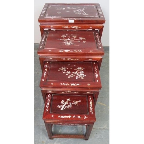 724 - A vintage Chinese hardwood quartetto of nesting tables, featuring mother of pearl inlay depicting so... 