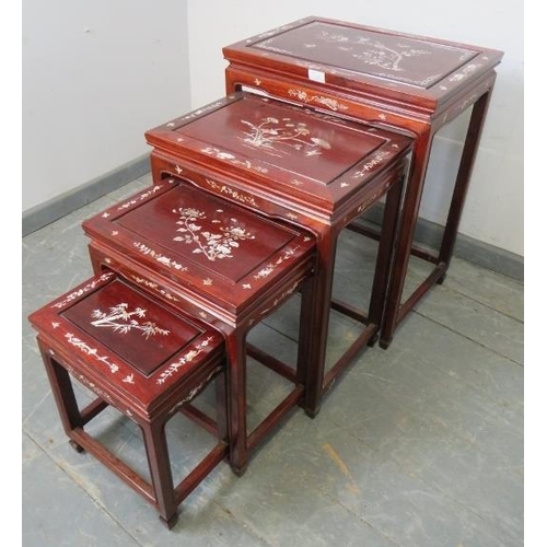 724 - A vintage Chinese hardwood quartetto of nesting tables, featuring mother of pearl inlay depicting so... 