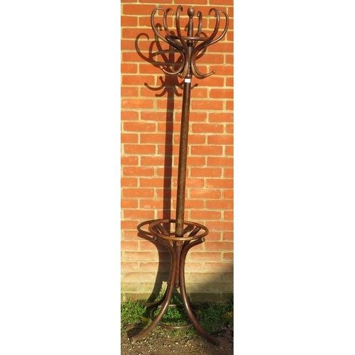 726 - A vintage bentwood hall stand with six hat and coat hooks and umbrella rack below, on splayed suppor... 