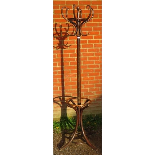 726 - A vintage bentwood hall stand with six hat and coat hooks and umbrella rack below, on splayed suppor... 