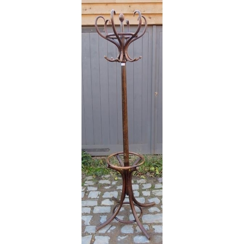 726 - A vintage bentwood hall stand with six hat and coat hooks and umbrella rack below, on splayed suppor... 