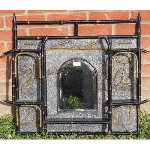 727 - An aesthetic period ebonised bamboo wall hanging shelf, with central arched and bevelled mirror.
Con... 