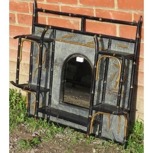 727 - An aesthetic period ebonised bamboo wall hanging shelf, with central arched and bevelled mirror.
Con... 