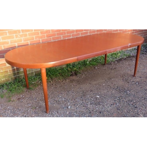 731 - A mid-century Danish teak oval draw-leaf extending dining table, with two additional leaves, on tape... 