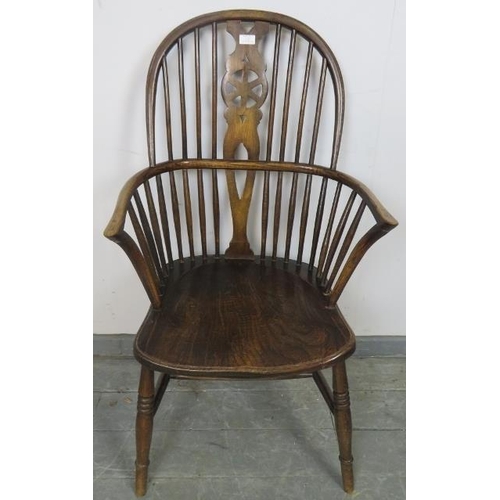 739 - A Georgian elm wheelback Windsor armchair, on turned supports with an ‘H’ stretcher. 
Condition repo... 