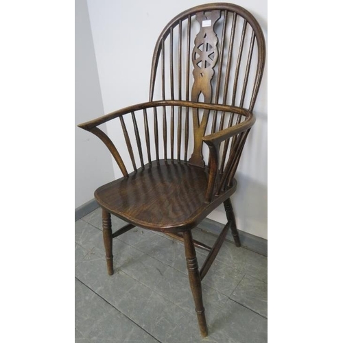 739 - A Georgian elm wheelback Windsor armchair, on turned supports with an ‘H’ stretcher. 
Condition repo... 