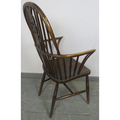 739 - A Georgian elm wheelback Windsor armchair, on turned supports with an ‘H’ stretcher. 
Condition repo... 