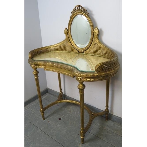 742 - A vintage French giltwood dressing table, the double skin bergère gallery supporting a bevelled oval... 