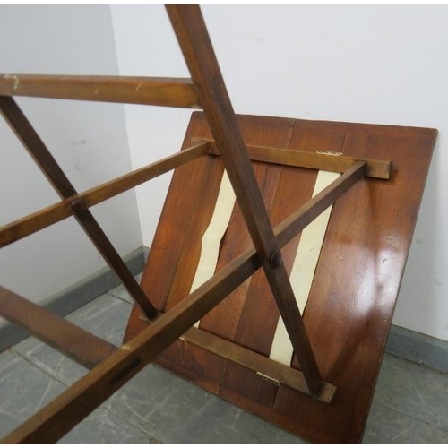 745 - A 19th century mahogany folding campaign card table, with cast iron fittings, the canvas straps secu... 