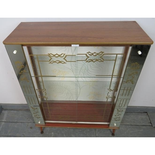 754 - A 1950s mirrored glazed display cabinet, housing two loose glass shelves, on dansette legs. 
Conditi... 