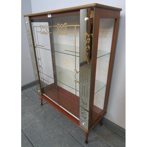 754 - A 1950s mirrored glazed display cabinet, housing two loose glass shelves, on dansette legs. 
Conditi... 