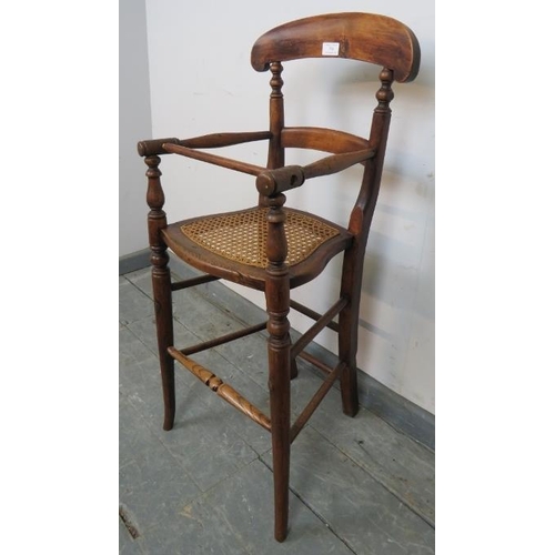 756 - An Edwardian oak child’s highchair with bergère seat, on turned supports with stretchers. 
Condition... 