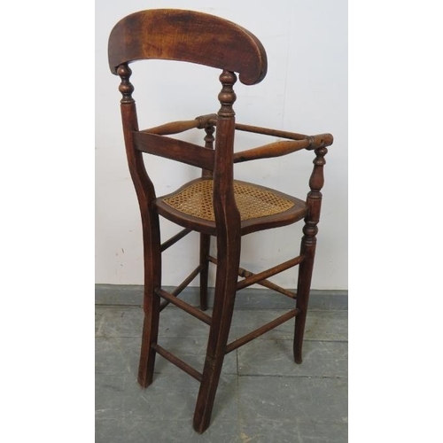 756 - An Edwardian oak child’s highchair with bergère seat, on turned supports with stretchers. 
Condition... 