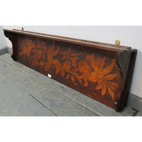 758 - An Arts & Crafts stained pine wall hanging shelf, with pokerwork frieze depicting cherubs and fruit.... 