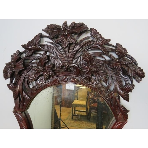 761 - A Victorian mahogany dressing mirror, the very ornate carved and pierced surround depicting entwined... 