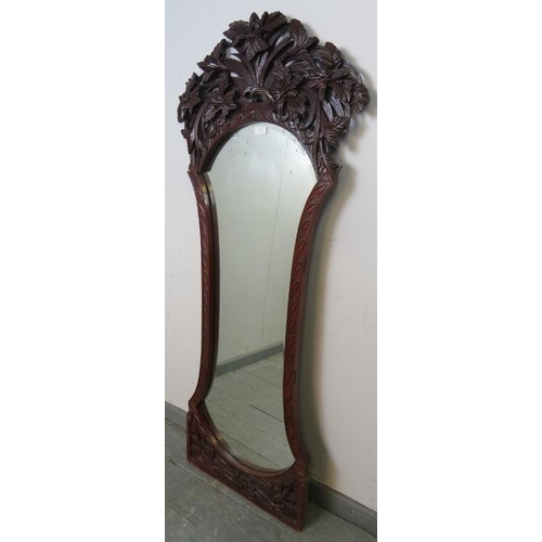 761 - A Victorian mahogany dressing mirror, the very ornate carved and pierced surround depicting entwined... 