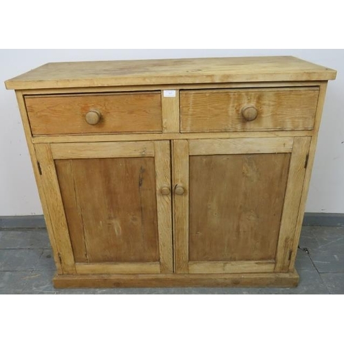 763 - An antique stripped pine sideboard, housing two short drawers with turned wooden knob handles, above... 