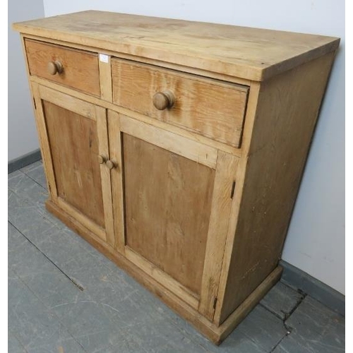 763 - An antique stripped pine sideboard, housing two short drawers with turned wooden knob handles, above... 