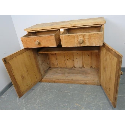 763 - An antique stripped pine sideboard, housing two short drawers with turned wooden knob handles, above... 