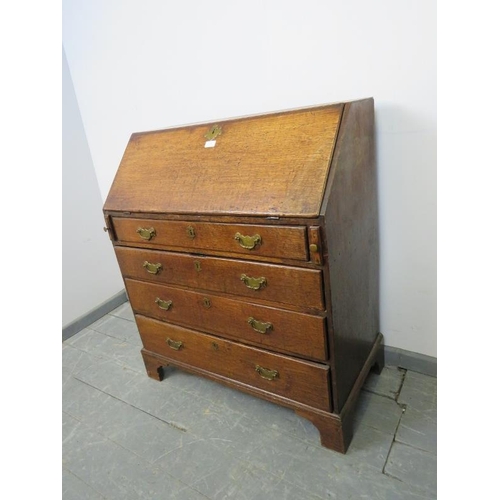 765 - An 18th century oak bureau of small proportions, the fall front opening onto a fitted interior with ... 