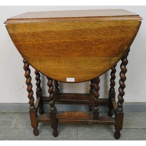 769 - An antique oak oval gateleg table of small proportions, on barley twist supports with stretchers. 
C... 