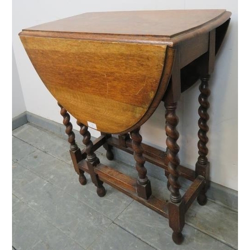 769 - An antique oak oval gateleg table of small proportions, on barley twist supports with stretchers. 
C... 