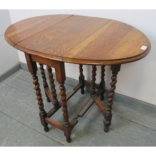 769 - An antique oak oval gateleg table of small proportions, on barley twist supports with stretchers. 
C... 